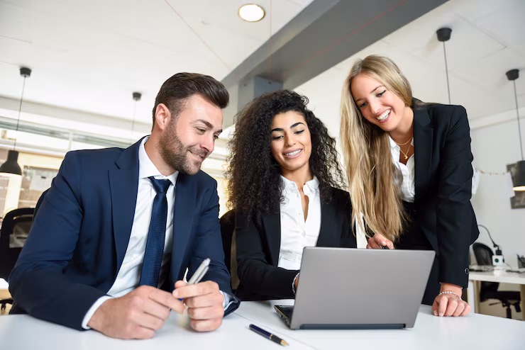 Equipo de trabajo reunido en oficina revisando un proyecto